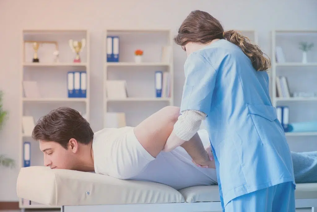 Male patient getting his elbow worked on by a chiropractor.
