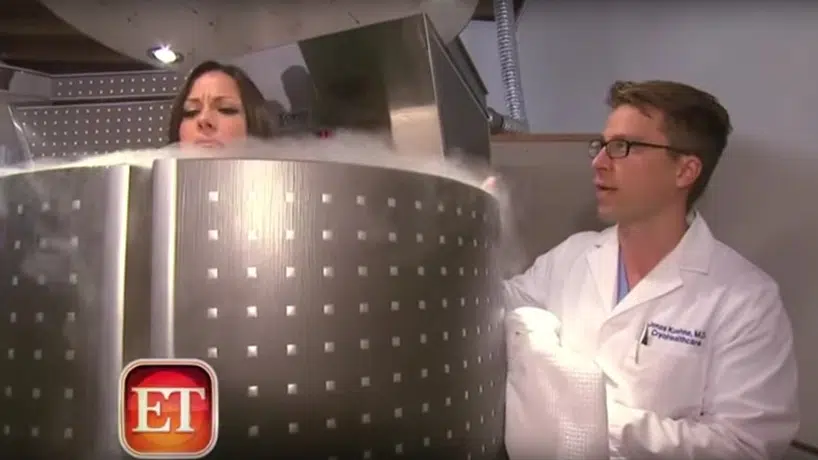 Doctor talking to a female patient inside of a Cryo-therapy machine