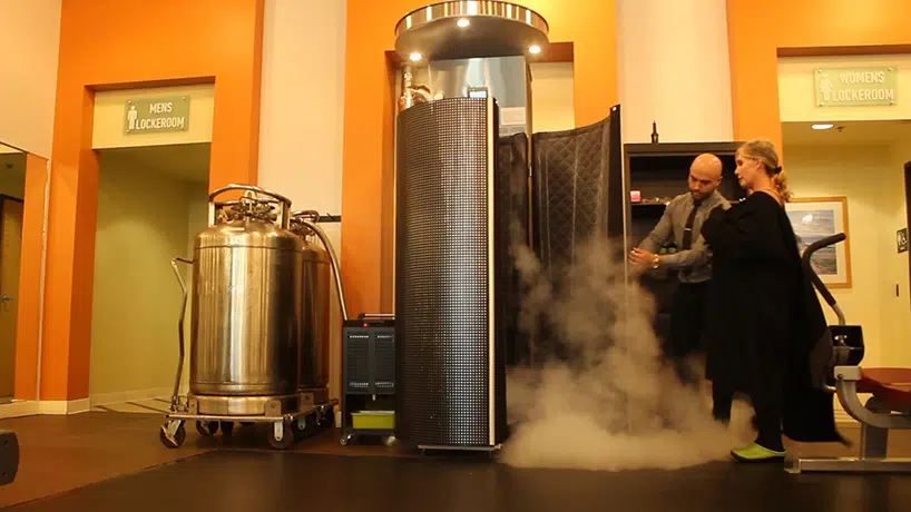 Doctor and patient beside a cryotherapy machine.