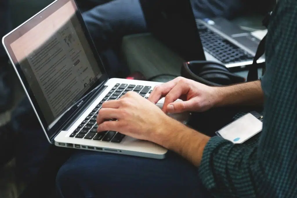 Typing woman has carpal tunnel causing hand and wrist pain.