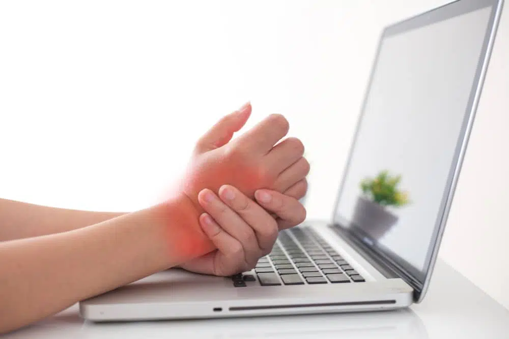 Woman holds hand because of arthritis pain in her hand.