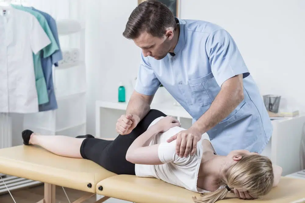 Chiropractor helps woman with muscle tears using an adjustment.