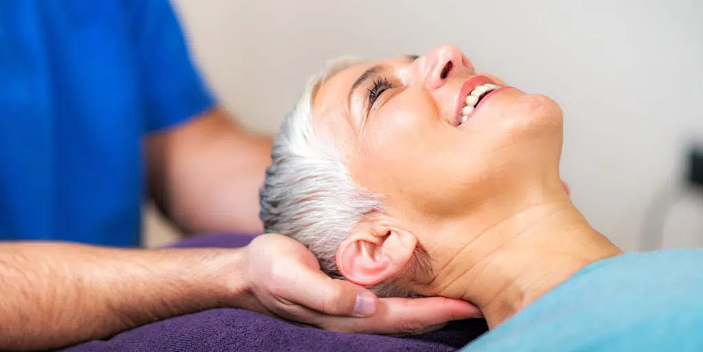 Chiropractor treating a senior patient's headache pain | Headache and Migraine Treatment