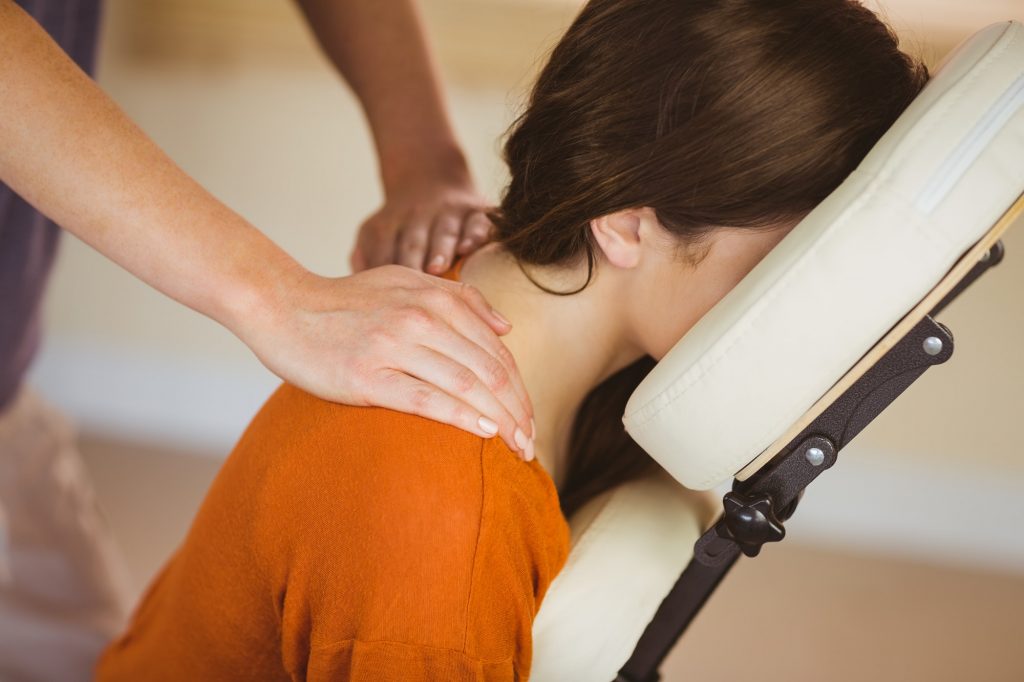 Young woman getting a neck massage