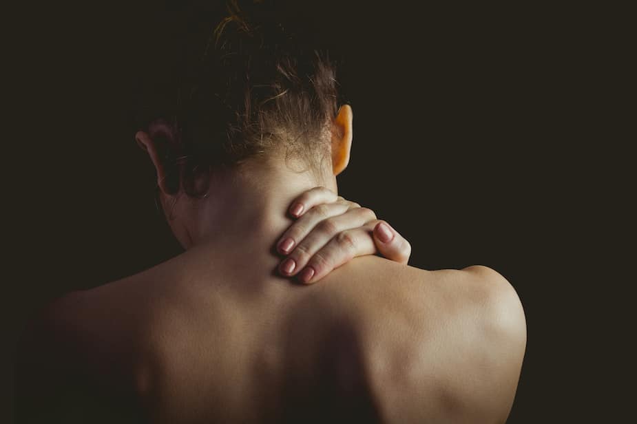 Young lady holding her neck due to pain