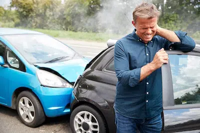 Man holding his neck due to a recent auto injury