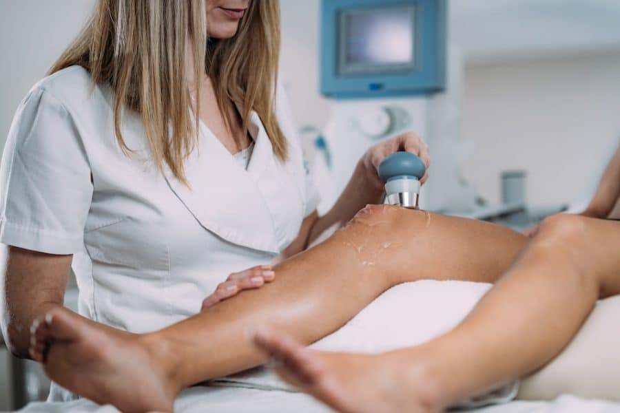 Doctor scanning patients knee with an ultrasound machine