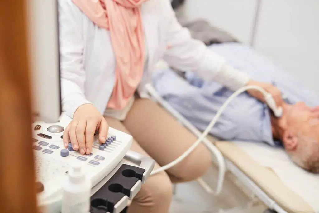 Doctor performing an ultrasound test on a patient