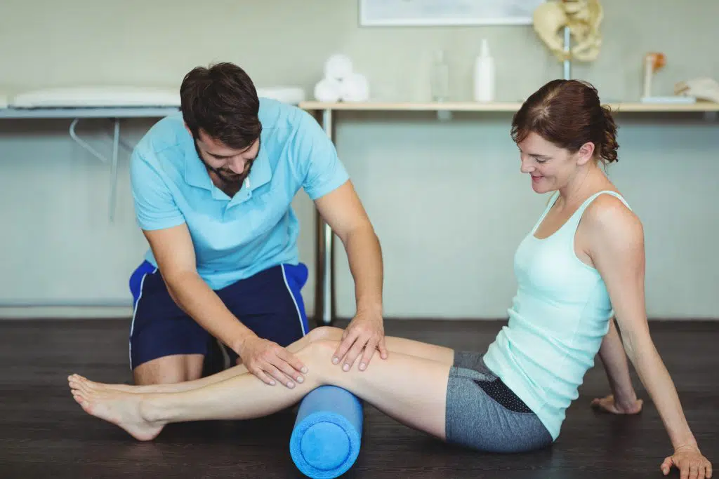 Chiropractor stretching patients knee