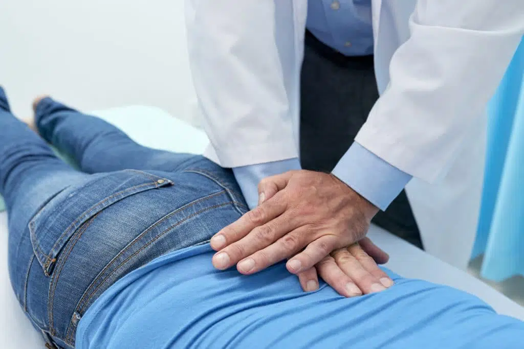 The best back pain doctor adjusting patients spine