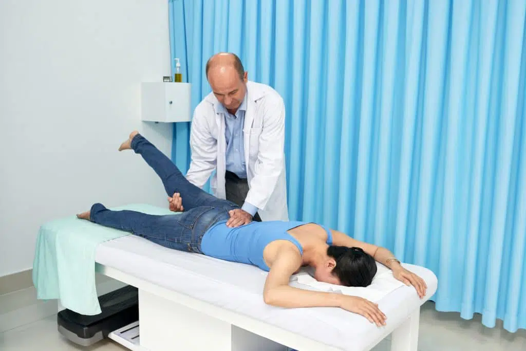 Chiropractor adjusting patients back