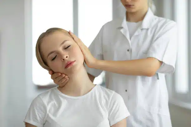 Chiropractor doing some neck adjustment on female patient