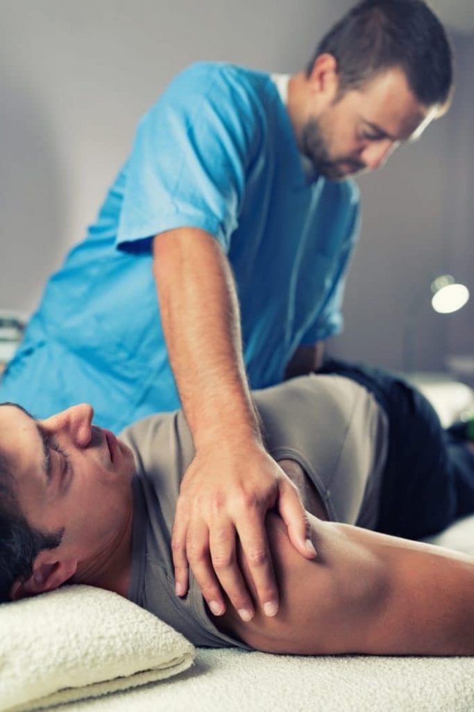 Chiropractor adjusting a patient with upper back problems.