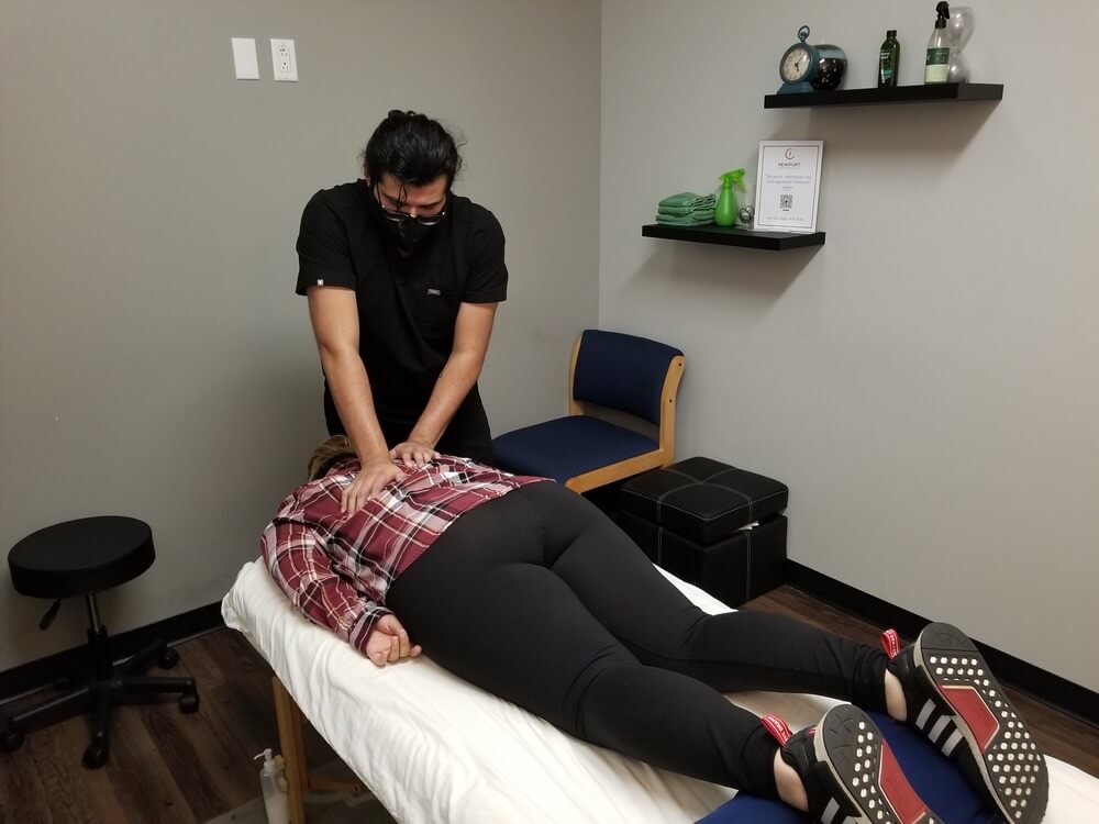 Chiropractor is doing some neck adjustment to the patient at the chiropractor clinic.