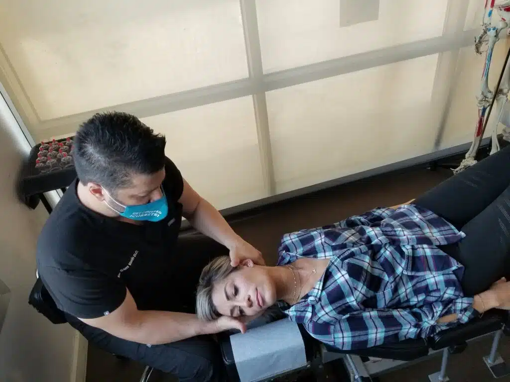chiropractor stretches neck of the patient