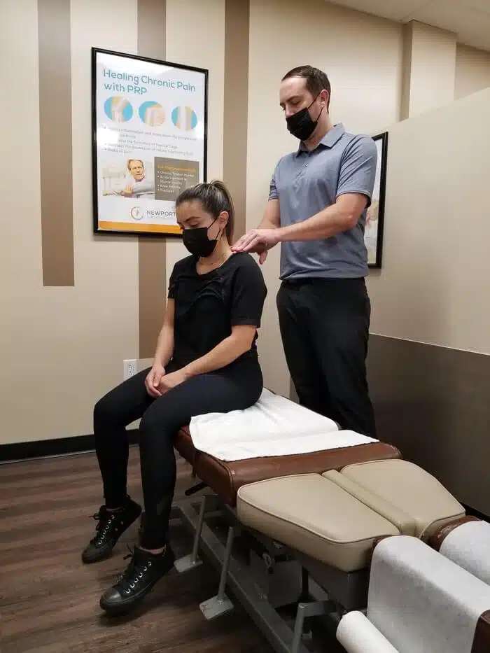 Chiropractor having some chiropractic adjustment session with a patient at Zaker chiropractic Torrance location.