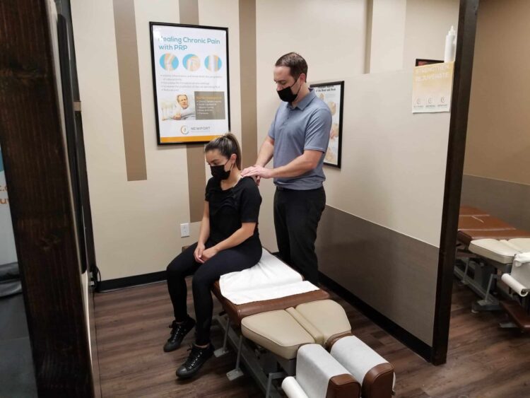 chiropractor massages patients neck