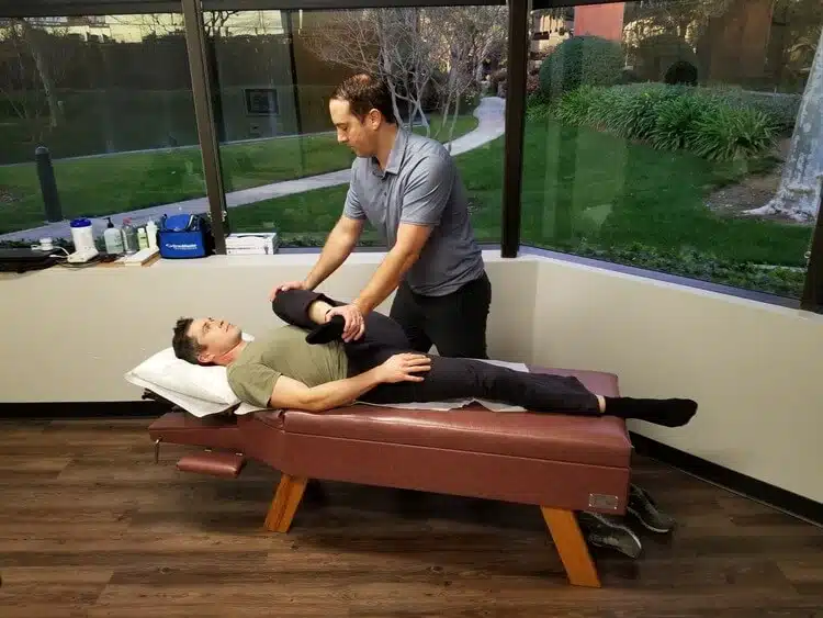 Chiropractor is doing some chiropractic adjustment to the patient at the chiropractor clinic.