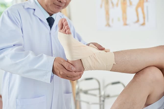 Doctor treating a patient with foot pain in newport.