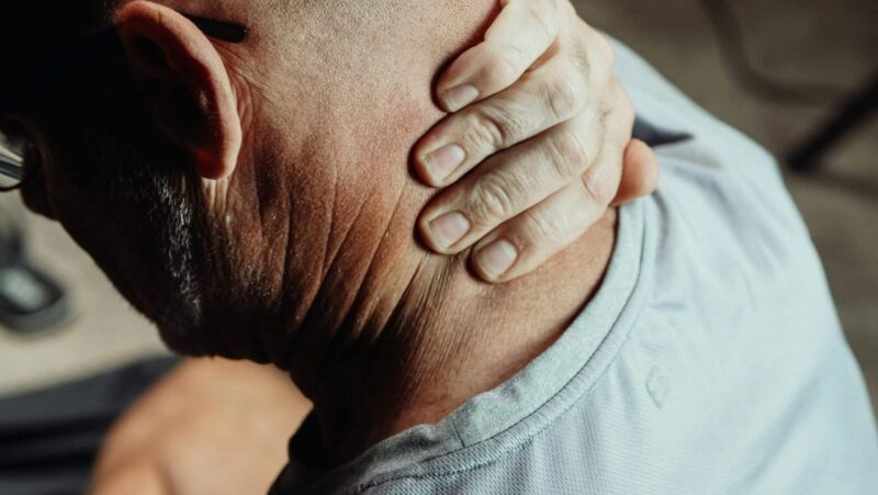 Man suffering from neck pain.