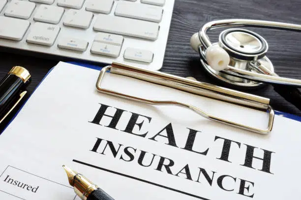 Individual health insurance policy and stethoscope.