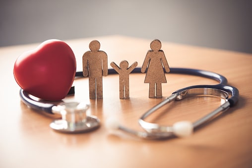 Health Insurance Concept With Family And Stethoscope On Wooden Desk