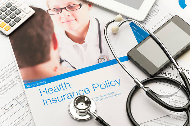 Health Insurance Policy brochure with paperwork.