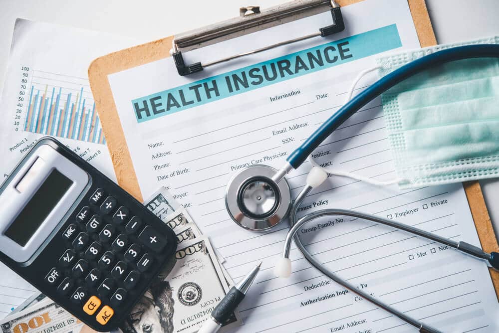 Health insurance information in a paper with a calculator 