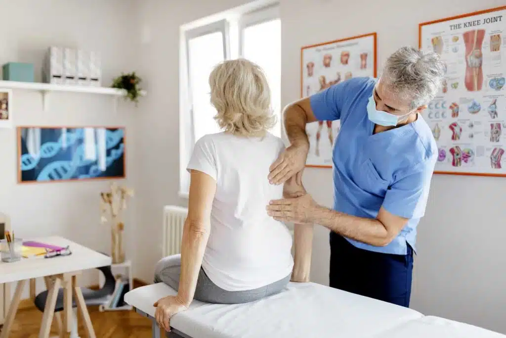 Senior woman is having her spinal adjustment with a chiropractor 