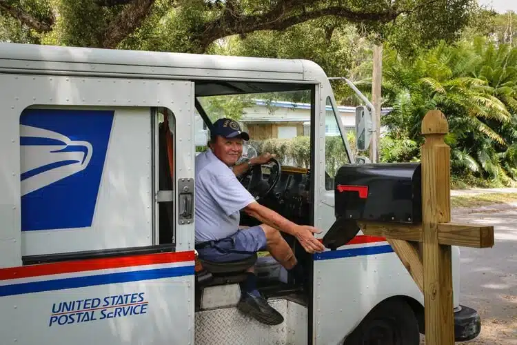 Postal worker inside his car. 