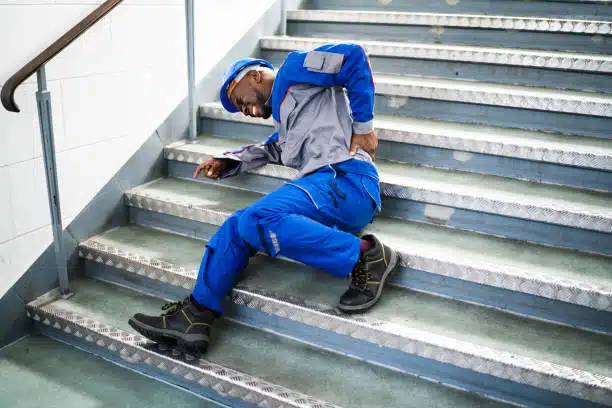 Worker Man Lying On Staircase After Slip And Fall Accident while at work.