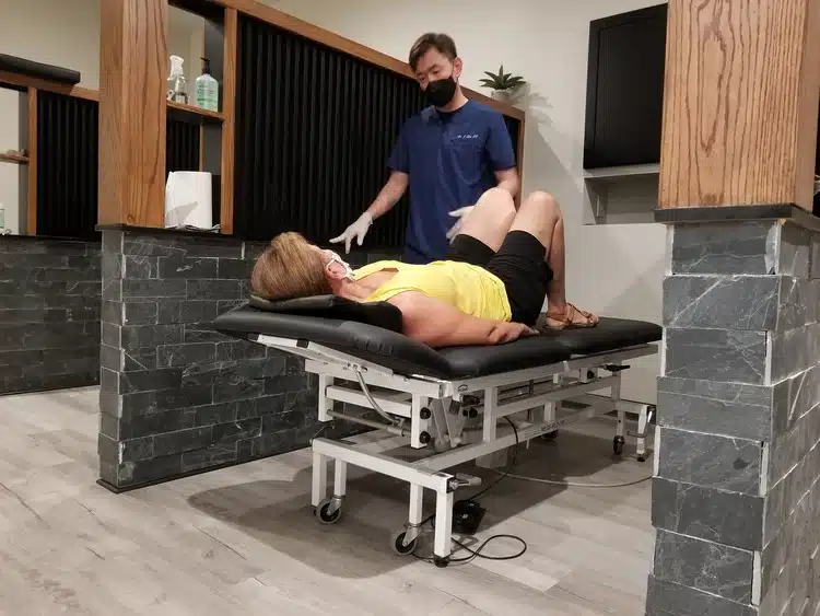 Chiropractor doing some hip adjustment to the patient