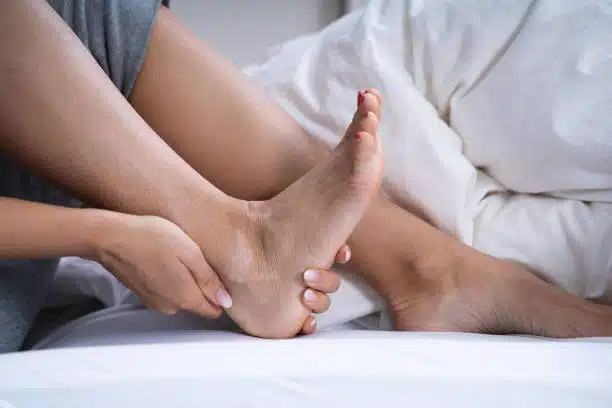 Woman suffers from foot pain caused by Tendonitis.