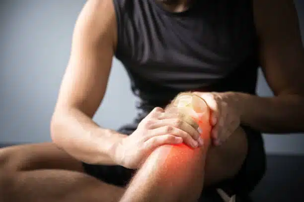 An athlete suffers from joint pain after getting involved into a sports accident.