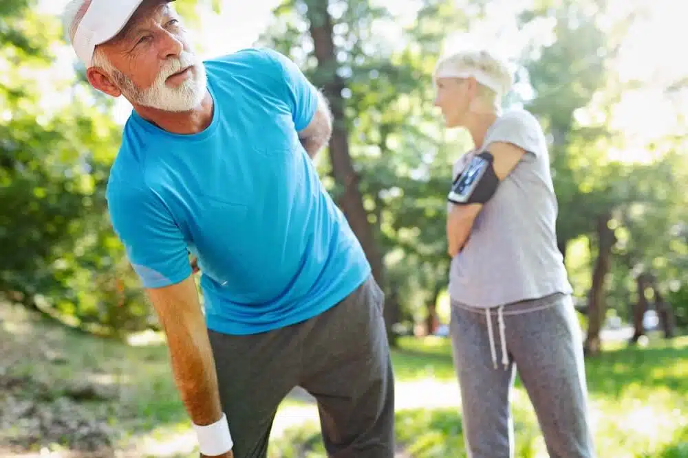 Senior man holding his knee feeling of pain caused by arthritis