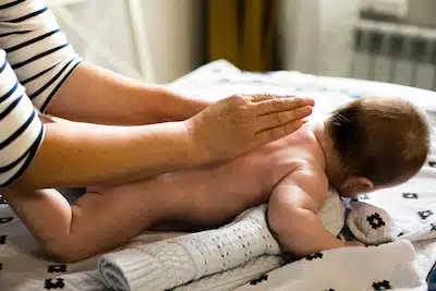 newborn baby getting back massage | Pediatric Chiropractic Care