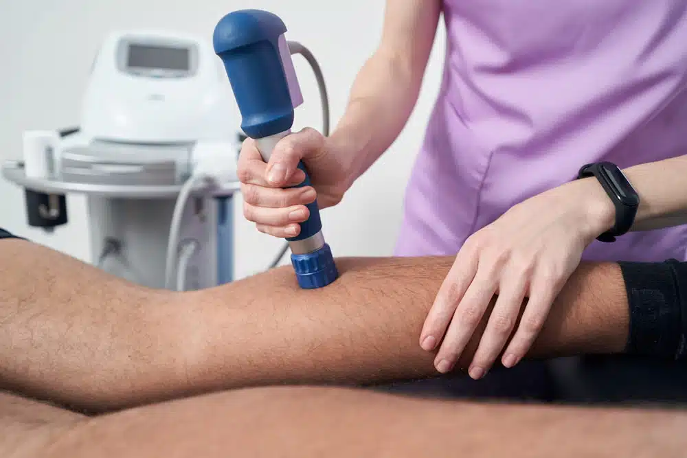 Non-Invasive and Safe Shockwave Therapy in Torrance applied to a patients leg for leg pain treatment
