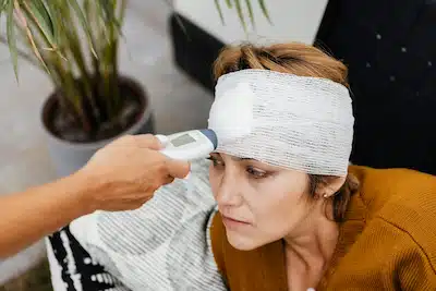 woman with head bandage due to concussion