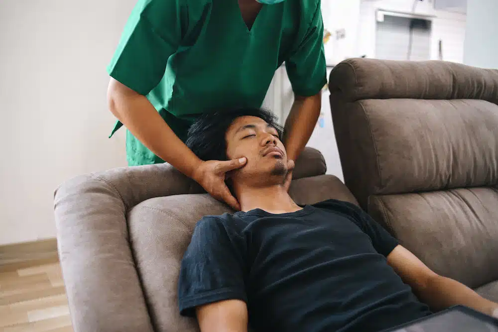 doctor massaging a patient with neck pain