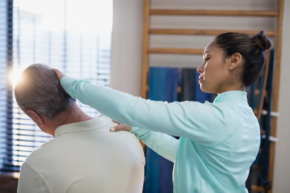 chiropractor applying different techniques on patient with neck pain