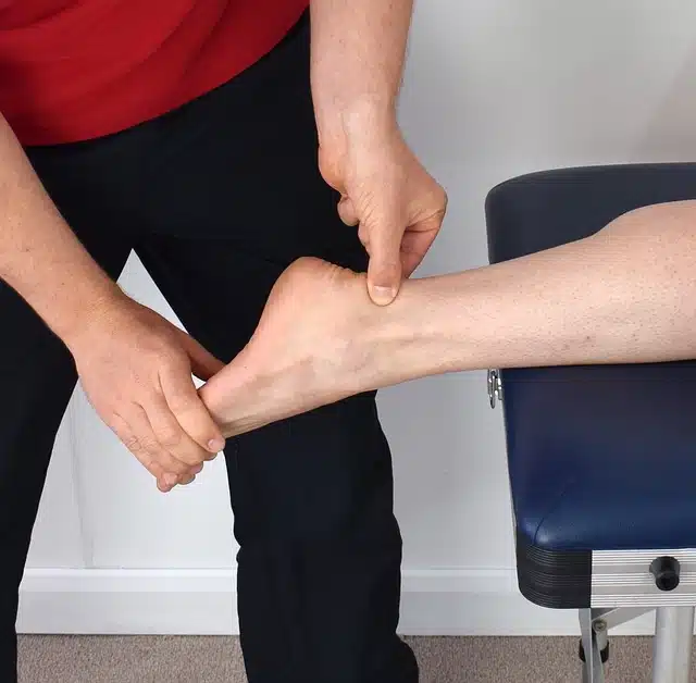 man getting chiropractic treatment for tendonitis on foot