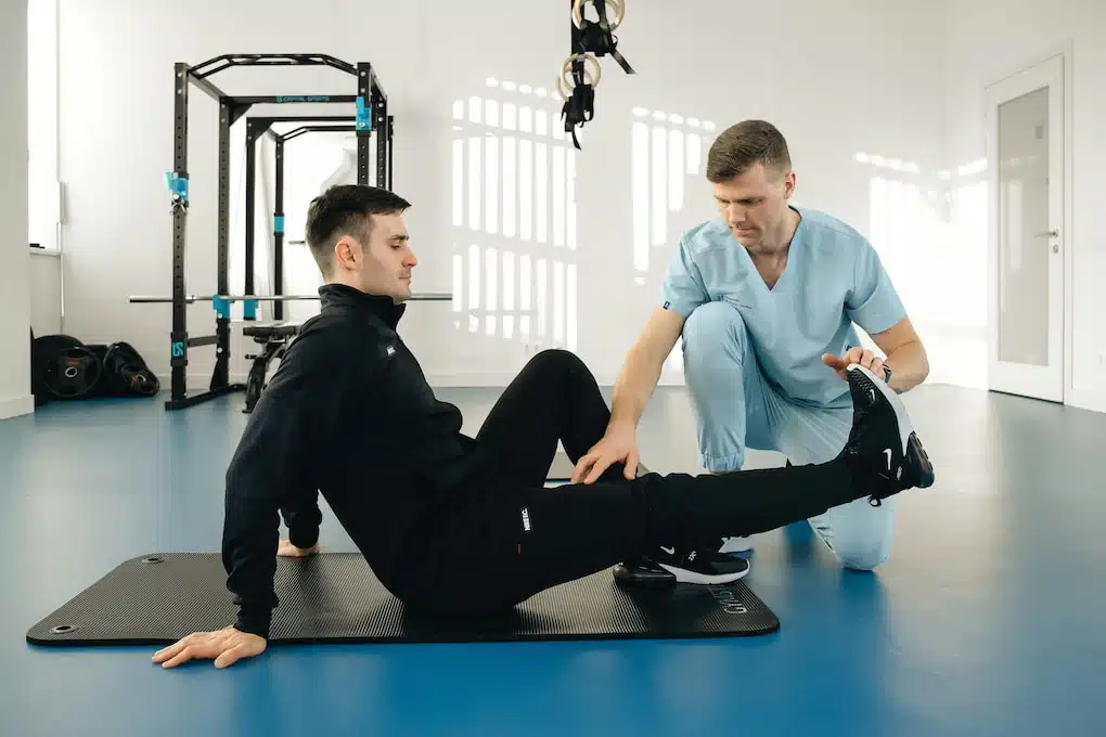 Man with leg pain injury having exercise therapy in a chiropractic clinic