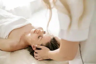 woman receiving chiropractic head massage for migraine relief