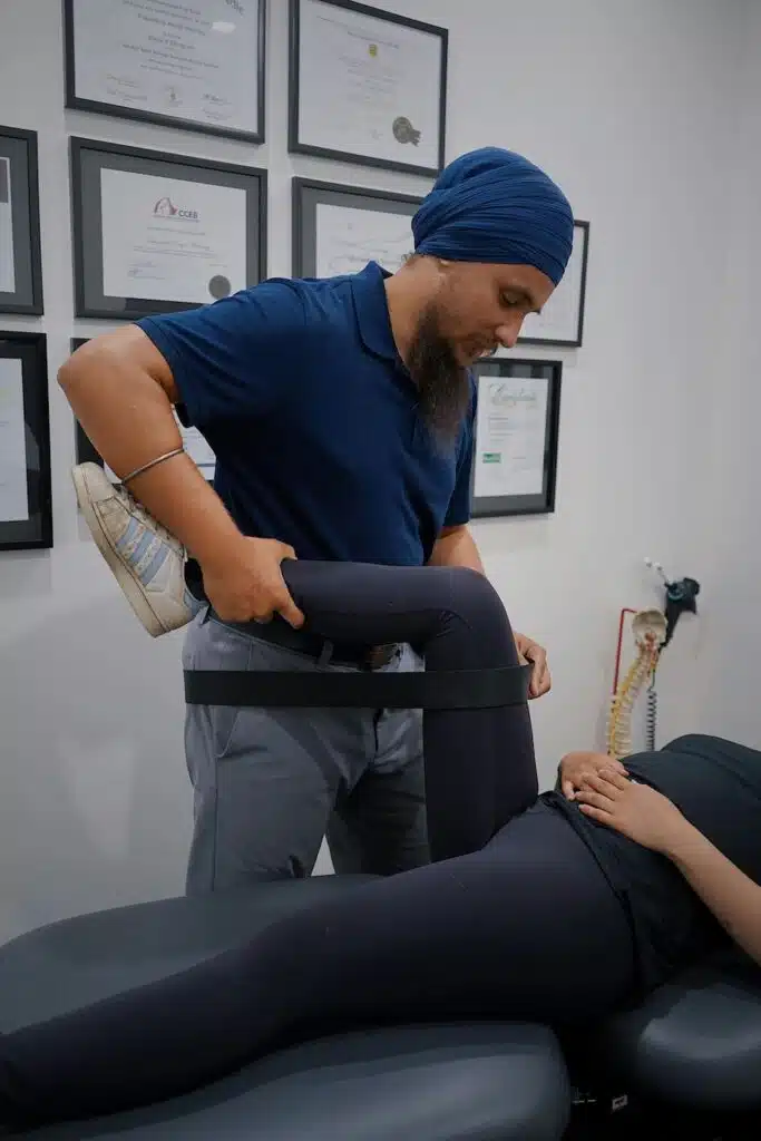 Chiropractor doing some massage therapy to the patient  that suffers from leg pain