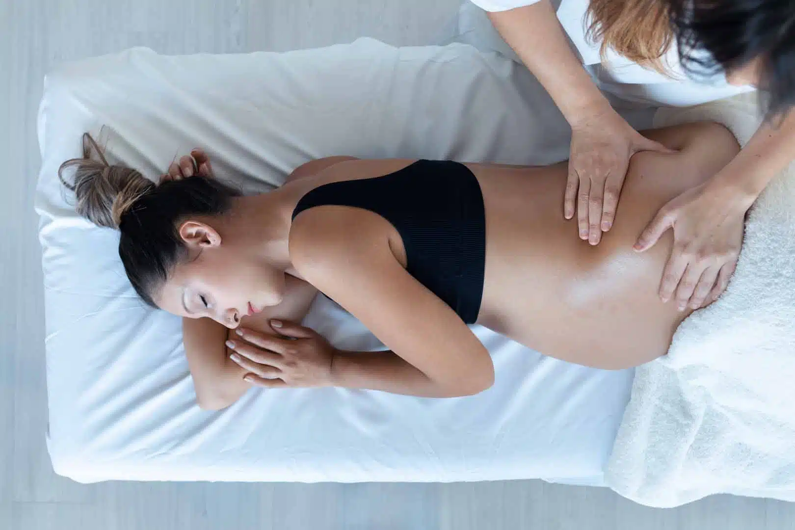 Shot of physiotherapist doing belly massage to pregnant patient