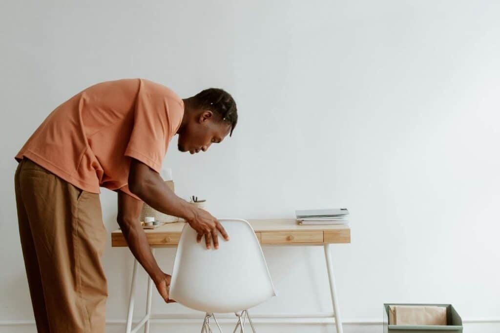 A man adjusting chair 