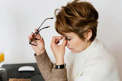 A Short-Haired Woman Holding a Pair of Eyeglasses