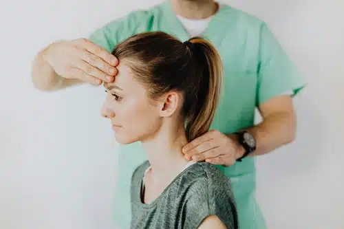 a woman receiving a headache therapy